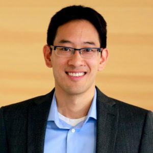 Timothy Chan, wearing a light blue shirt and a black blazer