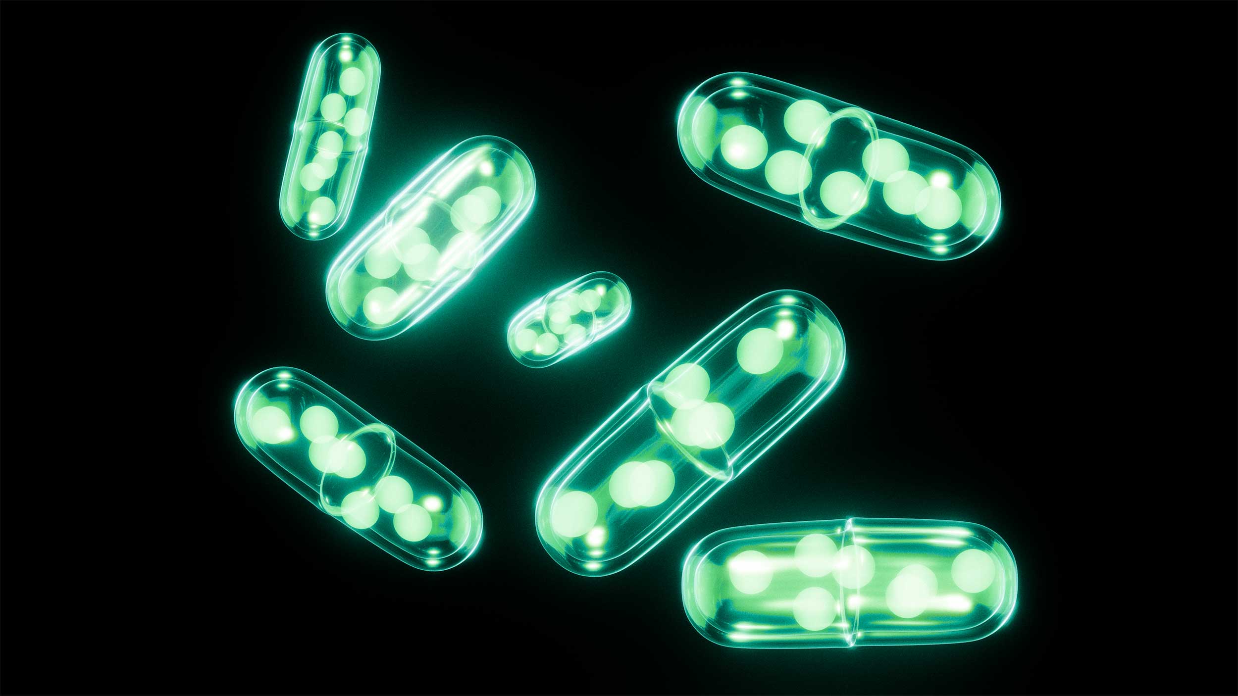 Seven glowing turquoise pill-shaped forms, containing smaller glowing spheres, scattered on a black background.