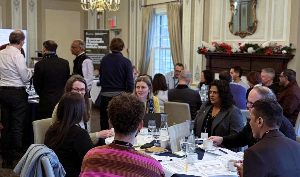 People at a workshop in discussion sitting around a table